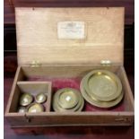 A box containing large sized brass sovereign weights