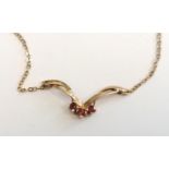 9ct .375 pendant and trace chain set three rubies formed as wings, London 1981