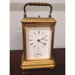 A 19th century repeater brass carriage clock, having Roman numerals and enamel dial complete with