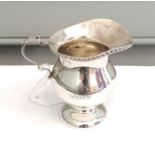 A Birmingham silver cream jug by S Blanckensee & Son Ltd dated 1919, engraved with initials and to