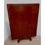 A large 19th century mahogany flip top breakfast table having a rectangular top, raised on