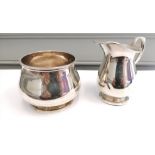 A Birmingham silver cream jug dated 1947 by Henry Matthews. 9cm in height (a.f) together with a