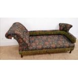 A late 19th century button backed chaise lounge upholstered in floral fabric and raised on turned