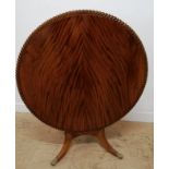 A 19th century flame mahogany breakfast table having a pie crust top, raised on splayed legs and