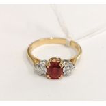 0.750 (18ct) Three stone ruby and diamond ring, diamonds 0.45cts approximately. London 1962.