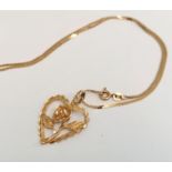 14K pendant and chain in the form of a heart and rose c1990. 4.7g approximately