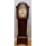 An early 19th century grandfather clock having a domed topped hood enclosing a painted dial with