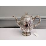 A Marshall and sons Edinburgh silver tea pot having repousse/chased c scroll and foliage design,