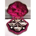 Cased set of four Victorian silver salts and spoons in the style of handled baskets with scalloped