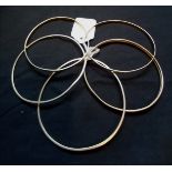 A collection of five various 9ct gold 375 bangles. 22g approximately.