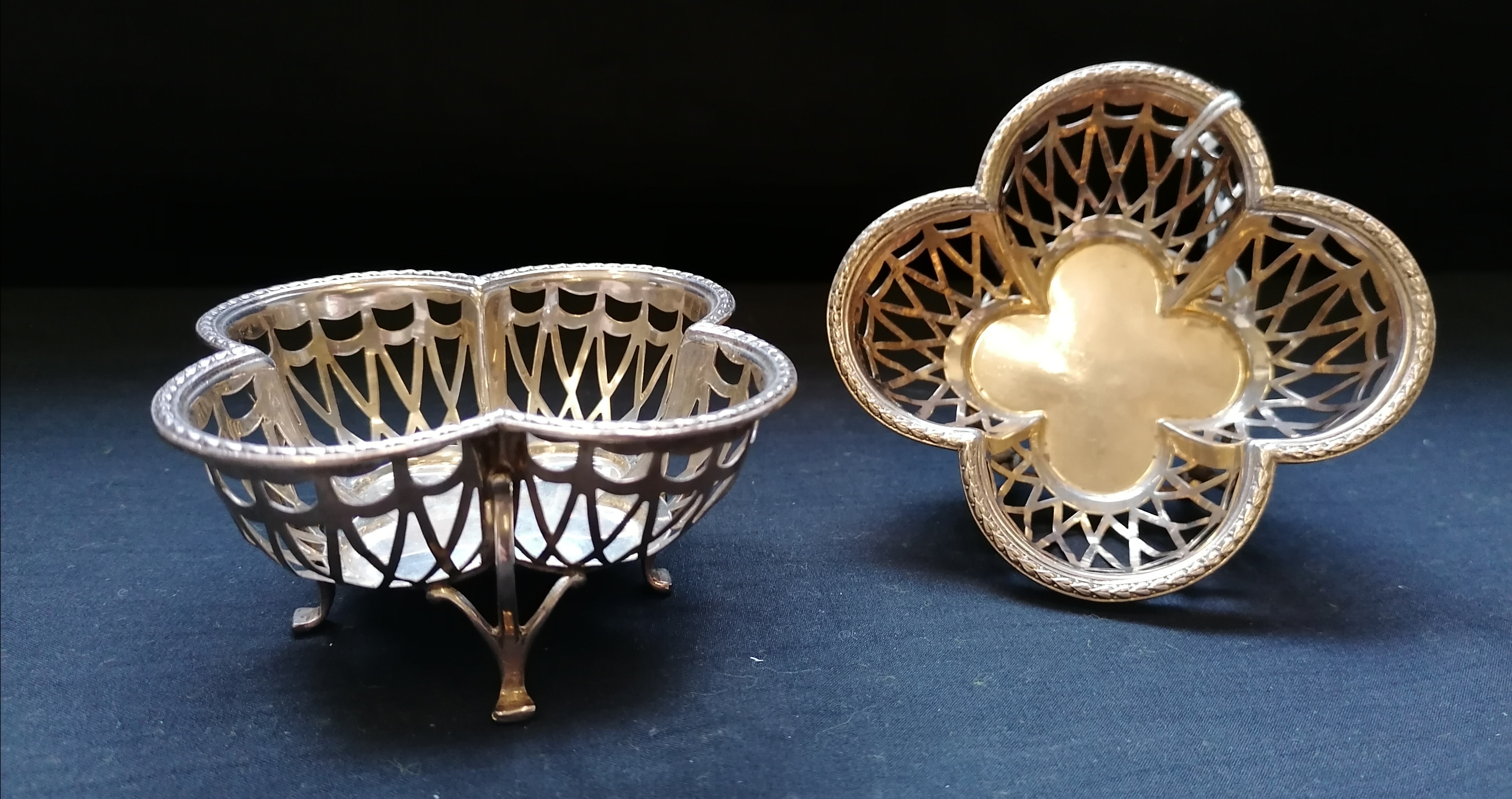 Matched pair of silver pierced quatrefoil bonbon dishes on claw feet. Makers Harry Synyer &