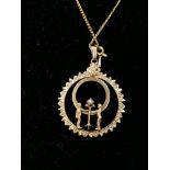 9ct gold pendant with inset pearl on a yellow metal chain.