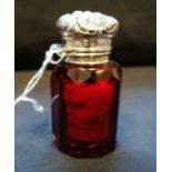 Victorian ruby glass scent bottle with chased silver top. Maker Charles May. Birmingham, 19--.