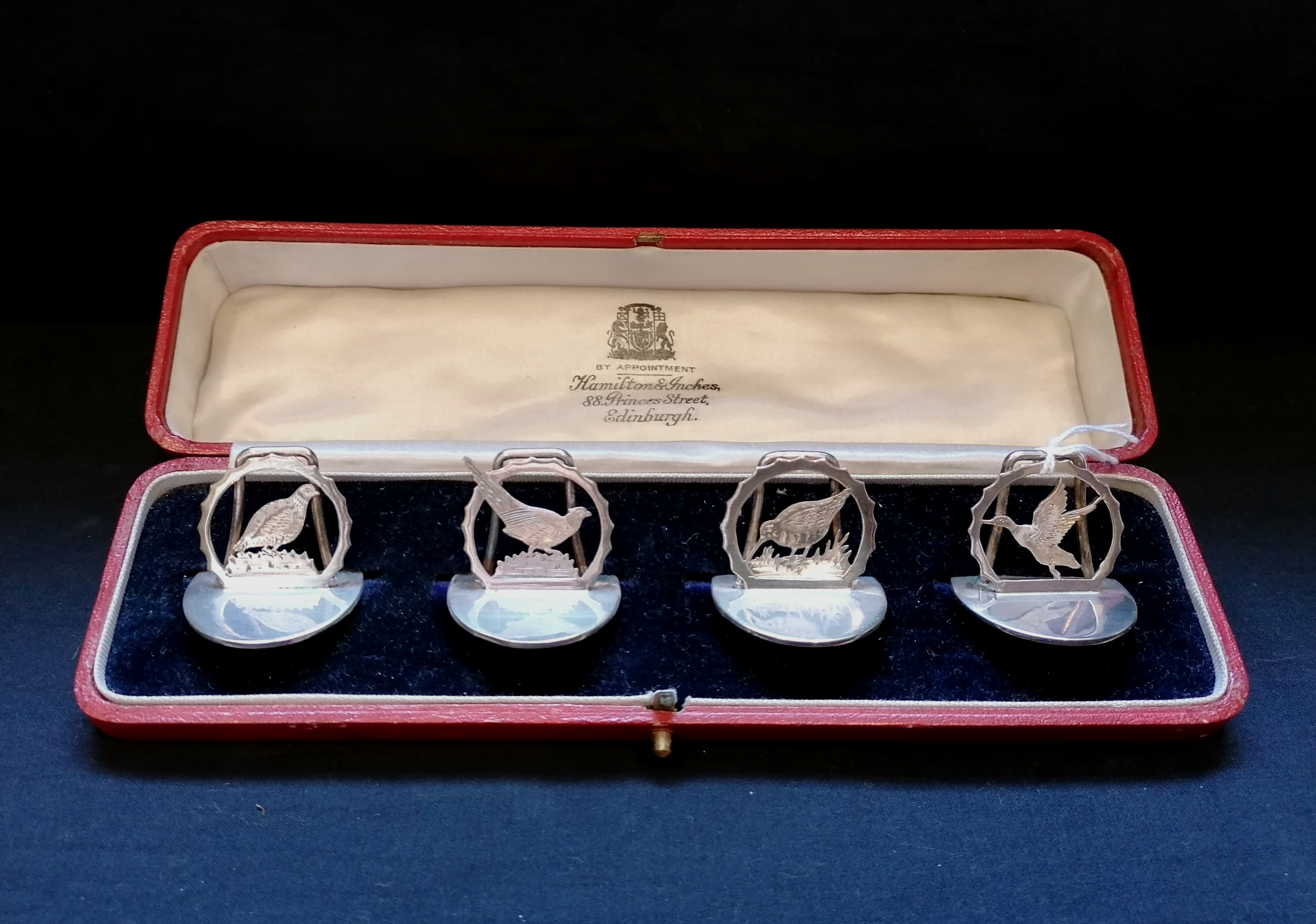 Cased set of four silver menu holders cast with game birds, Grouse, Pheasant, Snipe and duck. Makers