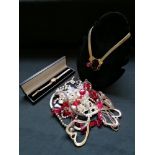 A box containing a collection of miscellaneous costume jewellery to include brooches, watches,