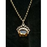 A 9ct gold chain with citrine pendant mounted in 9ct gold.