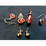 A collection of amber jewellery to include two silver and amber pendants, a pair of silver and amber