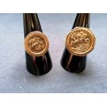 Two 9ct (375) gold St George medallion rings of varying sizes. 8g approximately.