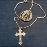 A 9ct gold cross together with a yellow metal chain.