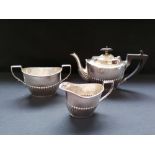 Three piece Victorian silver half lobed batchelor~s tea set. Sheffield, 1898. Makers Joseph