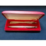 A boxed Birmingham silver pen set by William H Manton dated 1979.