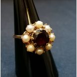 A 9ct gold and garnet and pearl ring. Ring size O.