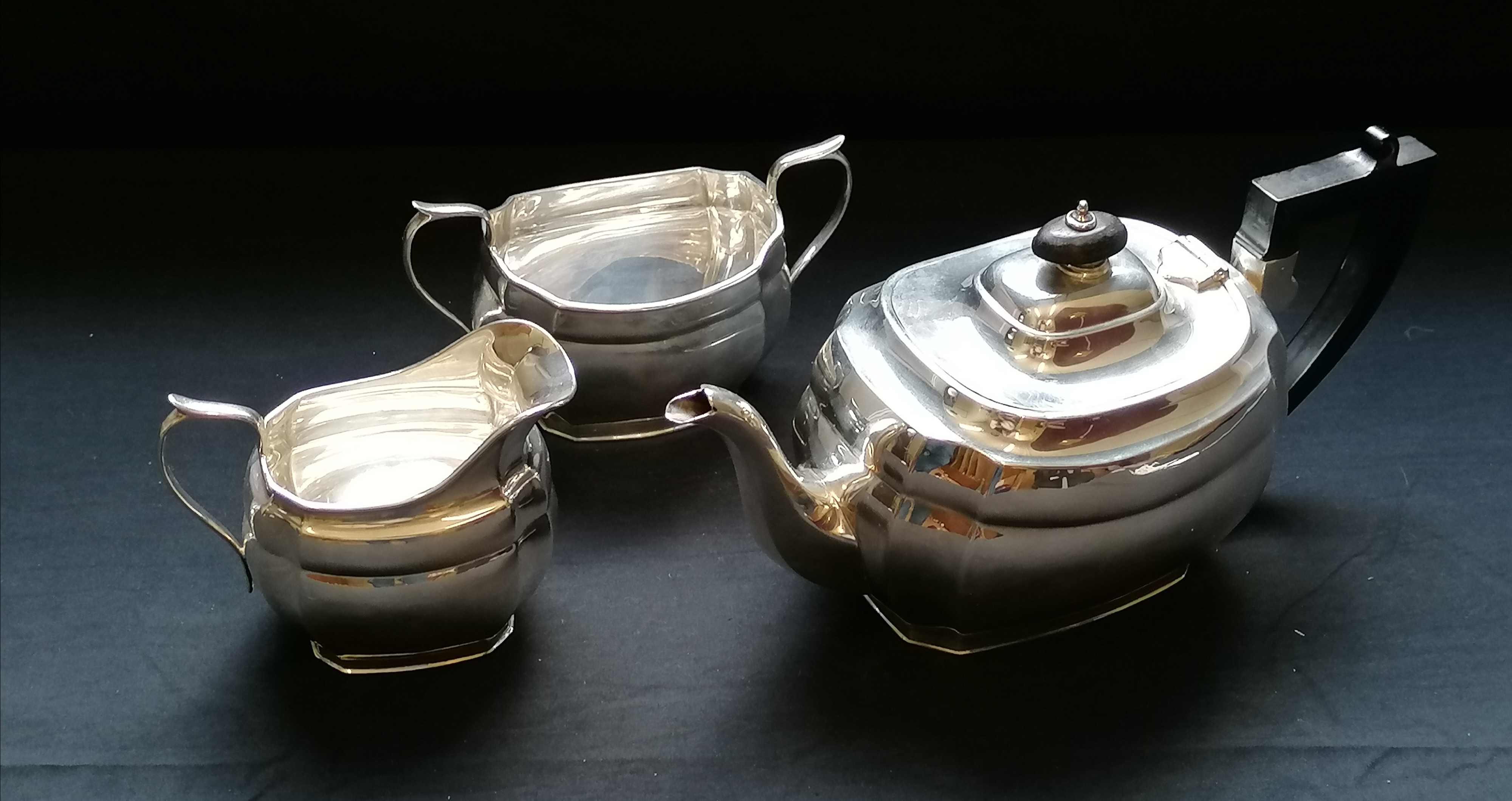 A three piece silver oval tea set with scalloped edge. Edinburgh, 1933. Makers Hamilton & Inches.