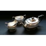 A three piece silver oval tea set with scalloped edge. Edinburgh, 1933. Makers Hamilton & Inches.