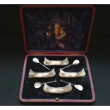 Unusual cased set of four silver salt cruets in the form of Indian canoes with original spoons and