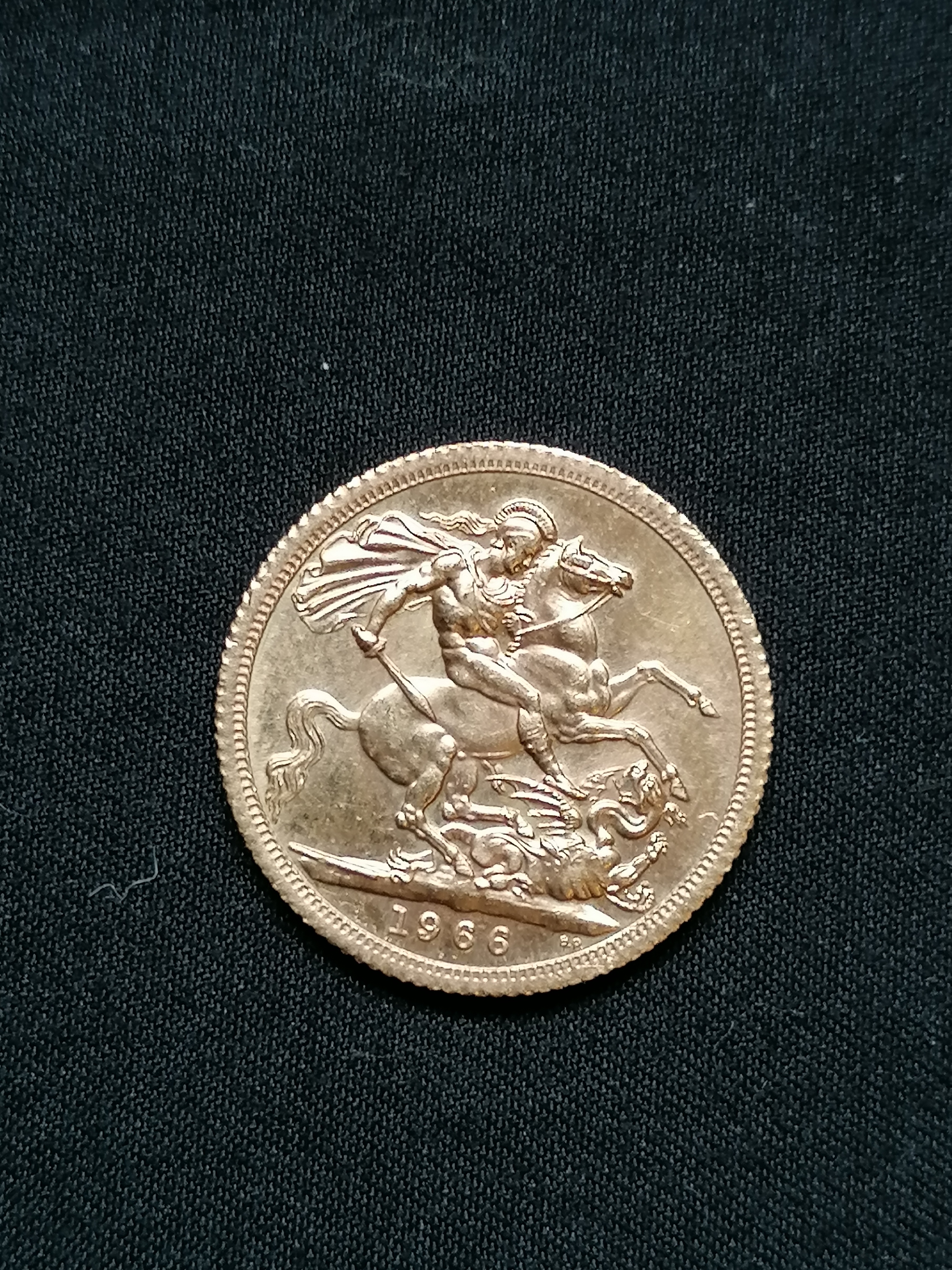 A 1966 gold Sovereign, Elizabeth II. 8g approximately.