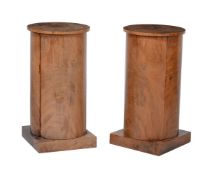 A pair of mahogany bedside cylinder pedestals