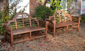 A pair of teak garden benches