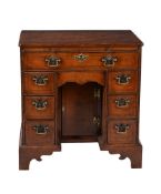 A George II walnut and feather banded kneehole desk