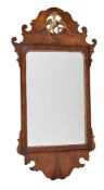 A George III walnut and parcel gilt fretwork wall mirror