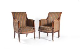 A pair of walnut bergeres in Regency taste