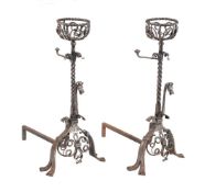 A pair of Continental, probably Northern European, wrought steel andirons in Gothic Revival taste