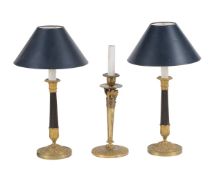 A pair of parcel gilt and patinated metal table lamps in the manner of Charles X candlesticks