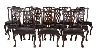 A set of twelve carved mahogany dining chairs
