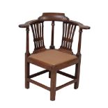 A George III mahogany corner armchair