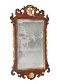 A George III mahogany and parcel gilt fretwork wall mirror