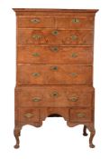 A George II walnut and featherbanded chest on stand