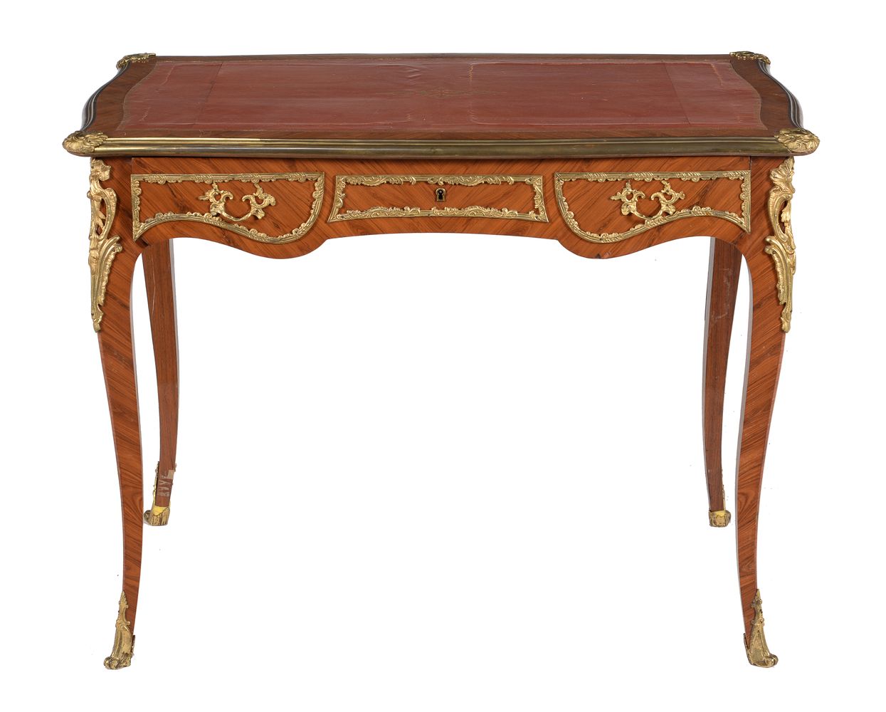 ϒ A tulipwood and gilt metal mounted writing table in Louis XVI style