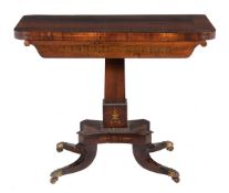 ϒ A Regency rosewood and brass inlaid card table