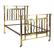 An Art Nouveau gilt brass bed