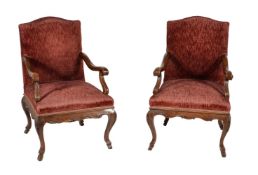 A pair of carved walnut armchairs in Continental early 18th century style