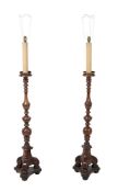 A pair of turned walnut standard lamps