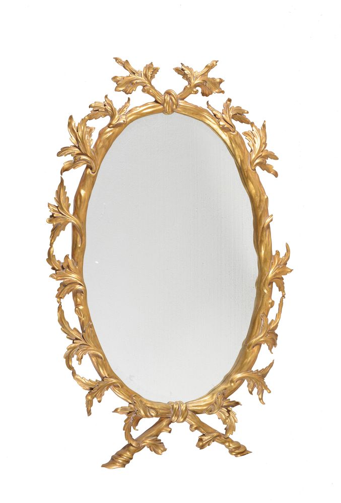 A gilt composition oval wall mirror in George III style