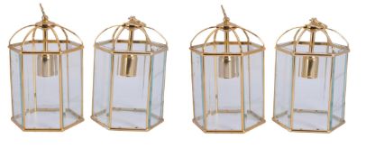 A set of four gilt metal and glazed hexagonal hall lanterns