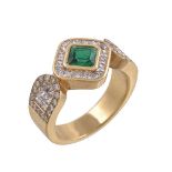 An emerald and diamond ring