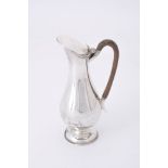 A late Victorian silver elongated baluster hot water jug by Joseph Rogers and Sons